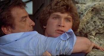 Movie still from “The Fury” (1978), directed by Brian De Palma – A man holding another man's arm while they look at each other; Close Up shot, Low angle