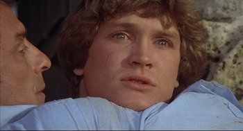 Movie still from “The Fury” (1978), directed by Brian De Palma – A person looking at the camera; Close Up shot, Low angle