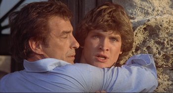 Movie still from “The Fury” (1978), directed by Brian De Palma – A man and a woman embracing each other; Close Up shot, Over the shoulder angle