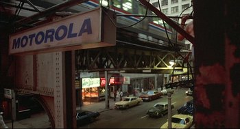 Movie still from “The Fury” (1978), directed by Brian De Palma – A view of a city street from a window; Extreme Wide shot, Low angle