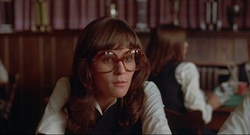 Movie still from “The Fury” (1978), directed by Brian De Palma – A woman with long brown hair wearing glasses; Close Up shot, Low angle