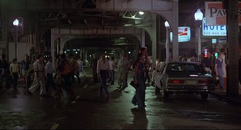 Movie still from “The Fury” (1978), directed by Brian De Palma – A group of people walking on a street at night; Wide shot, High angle