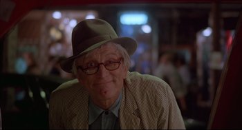 Movie still from “The Fury” (1978), directed by Brian De Palma – An older man wearing a hat and glasses; Close Up shot, Over the shoulder angle