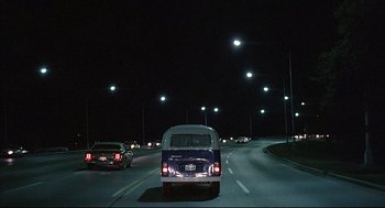 Movie still from “The Fury” (1978), directed by Brian De Palma – A van driving down a street at night with lights on; Extreme Wide shot, Low angle