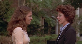 Movie still from “The Fury” (1978), directed by Brian De Palma – Two women talking to each other in front of trees; Close Up shot, Over the shoulder angle