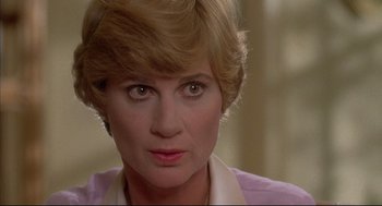 Movie still from “The Fury” (1978), directed by Brian De Palma – A person with short blonde hair; Close Up shot, Over the shoulder angle