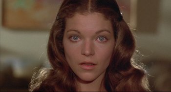 Movie still from “The Fury” (1978), directed by Brian De Palma – A woman's face in a dark room; Close Up shot, Low angle