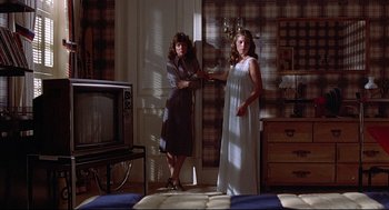 Movie still from “The Fury” (1978), directed by Brian De Palma – Two women standing next to each other in a room; Wide shot, Low angle