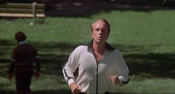 Movie still from “The Fury” (1978), directed by Brian De Palma – A man running in a park on a sunny day; Medium shot, Low angle