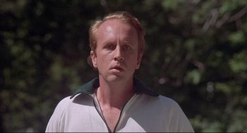 Movie still from “The Fury” (1978), directed by Brian De Palma – A person wearing a white shirt; Close Up shot, Low angle