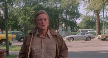 Movie still from “The Fury” (1978), directed by Brian De Palma – An older man standing in front of a car; Medium shot, Low angle