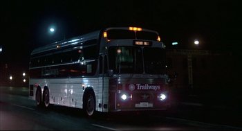 Movie still from “The Fury” (1978), directed by Brian De Palma – A bus driving down a street at night; Wide shot, Low angle