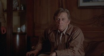 Movie still from “The Fury” (1978), directed by Brian De Palma – A person sitting in a chair; Medium shot, Over the shoulder angle