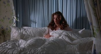 Movie still from “The Fury” (1978), directed by Brian De Palma – A woman laying in bed under a blanket; Medium shot, High angle