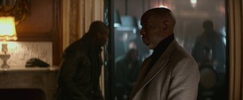 Movie still from “The Gambler” (2014), directed by Rupert Wyatt – A man standing in front of a mirror in a room; Medium shot, Over the shoulder angle