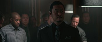 Movie still from “The Gambler” (2014), directed by Rupert Wyatt – A person wearing a suit and a tie; Close Up shot, Over the shoulder angle