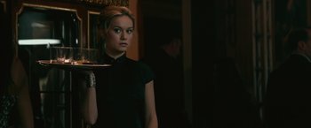Movie still from “The Gambler” (2014), directed by Rupert Wyatt – A woman in a black shirt holding a glass; Medium shot, Over the shoulder angle