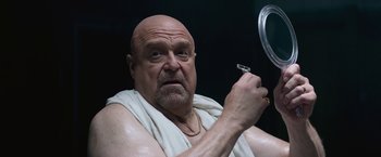 Movie still from “The Gambler” (2014), directed by Rupert Wyatt – A bald man in a white towel holding a razor; Close Up shot, Low angle