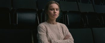 Movie still from “The Gambler” (2014), directed by Rupert Wyatt – A woman in a white sweater sitting in a chair; Close Up shot, Over the shoulder angle