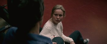 Movie still from “The Gambler” (2014), directed by Rupert Wyatt – A woman sitting in front of a man in a white sweater; Medium shot, Over the shoulder angle