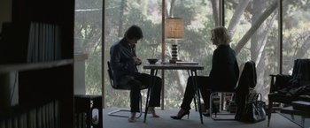 Movie still from “The Gambler” (2014), directed by Rupert Wyatt – A man and woman sitting at a table in front of each other; Wide shot, High angle