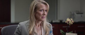 Movie still from “The Gambler” (2014), directed by Rupert Wyatt – A woman with blonde hair wearing a gray jacket; Close Up shot, Over the shoulder angle