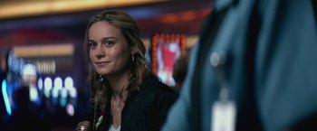 Movie still from “The Gambler” (2014), directed by Rupert Wyatt – A beautiful young lady sitting at a table; Close Up shot, Over the shoulder angle
