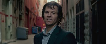 Movie still from “The Gambler” (2014), directed by Rupert Wyatt – A person wearing a suit; Close Up shot, Low angle