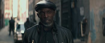 Movie still from “The Gambler” (2014), directed by Rupert Wyatt – A man wearing a hat and a leather jacket; Close Up shot, Low angle