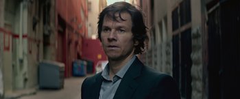 Movie still from “The Gambler” (2014), directed by Rupert Wyatt – A person wearing a suit and tie; Close Up shot, Low angle