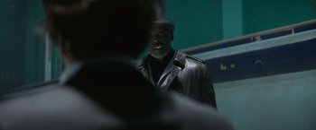 Movie still from “The Gambler” (2014), directed by Rupert Wyatt – A man wearing a leather jacket and a hat; Close Up shot, Over the shoulder angle