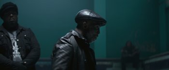 Movie still from “The Gambler” (2014), directed by Rupert Wyatt – A man wearing a leather jacket and a hat; Close Up shot, Low angle