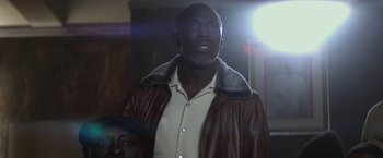 Movie still from “The Gambler” (2014), directed by Rupert Wyatt – A man wearing a brown leather jacket and a white shirt; Close Up shot, Low angle