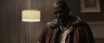 Movie still from “The Gambler” (2014), directed by Rupert Wyatt – A man wearing a brown leather jacket looking at the camera; Close Up shot, Low angle