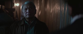 Movie still from “The Gambler” (2014), directed by Rupert Wyatt – An older man standing in front of a wall; Close Up shot, Low angle