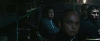 Movie still from “The Gambler” (2014), directed by Rupert Wyatt – A man sitting in a chair in a dark room; Close Up shot, Over the shoulder angle