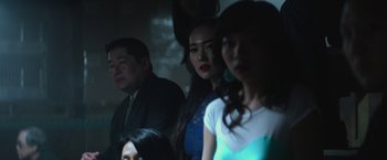 Movie still from “The Gambler” (2014), directed by Rupert Wyatt – A group of people sitting in a dark room; Close Up shot, Over the shoulder angle