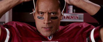 Movie still from “The Game Plan” (2007), directed by Andy Fickman – A person wearing a football uniform; Close Up shot, Overhead angle