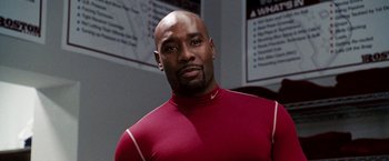 Movie still from “The Game Plan” (2007), directed by Andy Fickman – A man in a red shirt is looking at the camera; Close Up shot, Low angle