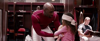 Movie still from “The Game Plan” (2007), directed by Andy Fickman – A man and a little girl are playing tug of war; Medium shot, Over the shoulder angle