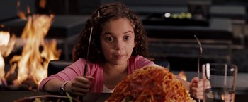 Movie still from “The Game Plan” (2007), directed by Andy Fickman – A young girl holding a fork in front of a plate of spaghetti; Close Up shot, High angle