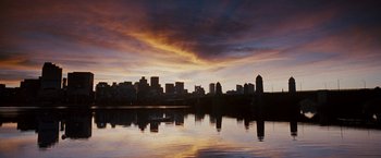 Movie still from “The Game Plan” (2007), directed by Andy Fickman – A view of a city skyline from across a body of water at sunset; Extreme Wide shot, Low angle