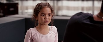 Movie still from “The Game Plan” (2007), directed by Andy Fickman – A little girl in a pink shirt talking to a man; Close Up shot, Over the shoulder angle