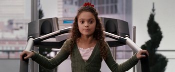 Movie still from “The Game Plan” (2007), directed by Andy Fickman – A young girl in a green sweater is standing on a treadmill; Close Up shot, High angle