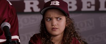 Movie still from “The Game Plan” (2007), directed by Andy Fickman – A girl with curly hair wearing a baseball cap; Close Up shot, High angle