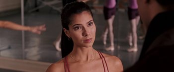 Movie still from “The Game Plan” (2007), directed by Andy Fickman – A beautiful woman wearing a red top and standing in front of other dancers; Close Up shot, Over the shoulder angle