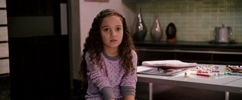 Movie still from “The Game Plan” (2007), directed by Andy Fickman – A little girl sitting on a chair in front of a coffee table; Close Up shot, High angle