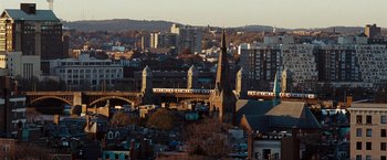 Movie still from “The Game Plan” (2007), directed by Andy Fickman – A view of a city with a church in the middle of it; Extreme Wide shot, High angle