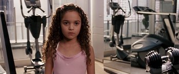 Movie still from “The Game Plan” (2007), directed by Andy Fickman – A little girl in a pink shirt in front of a gym; Close Up shot, High angle
