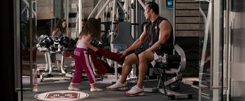 Movie still from “The Game Plan” (2007), directed by Andy Fickman – A man and a little girl in a gym; Medium shot, Over the shoulder angle